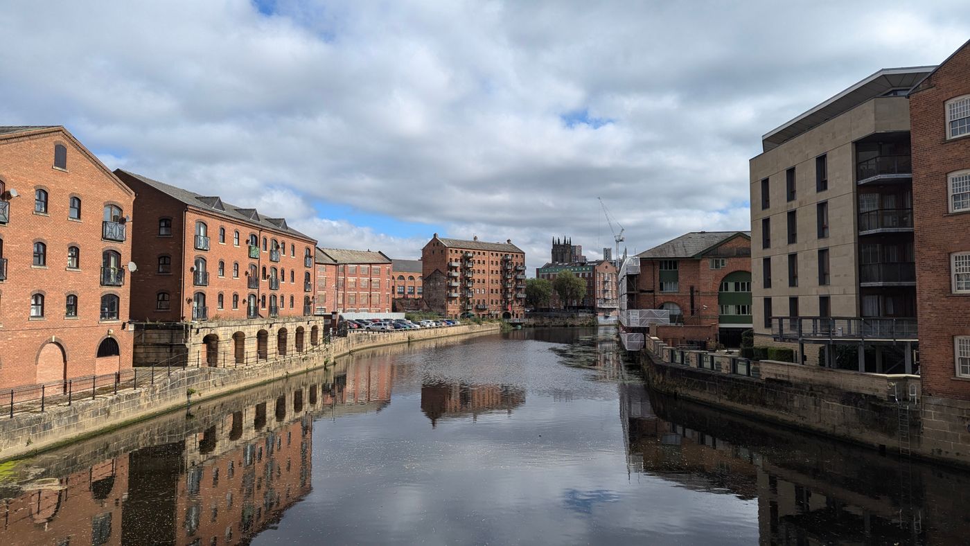 Historic brick buildings overlooking the River Aire in Leeds